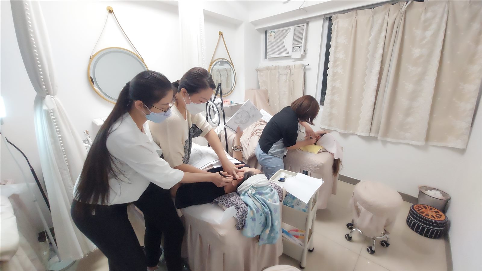 A woman in her fifties gently working the area between her brows with the rounded edge of a bojin stick
