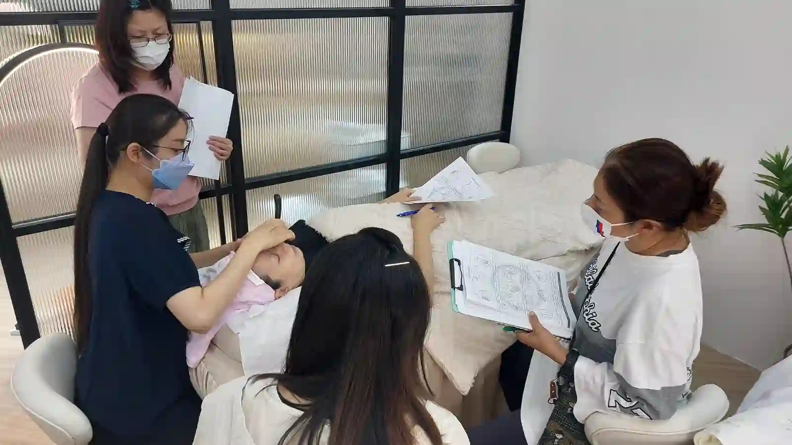A hand working the forehead and brow area, the exact spots glasses frames press on all day