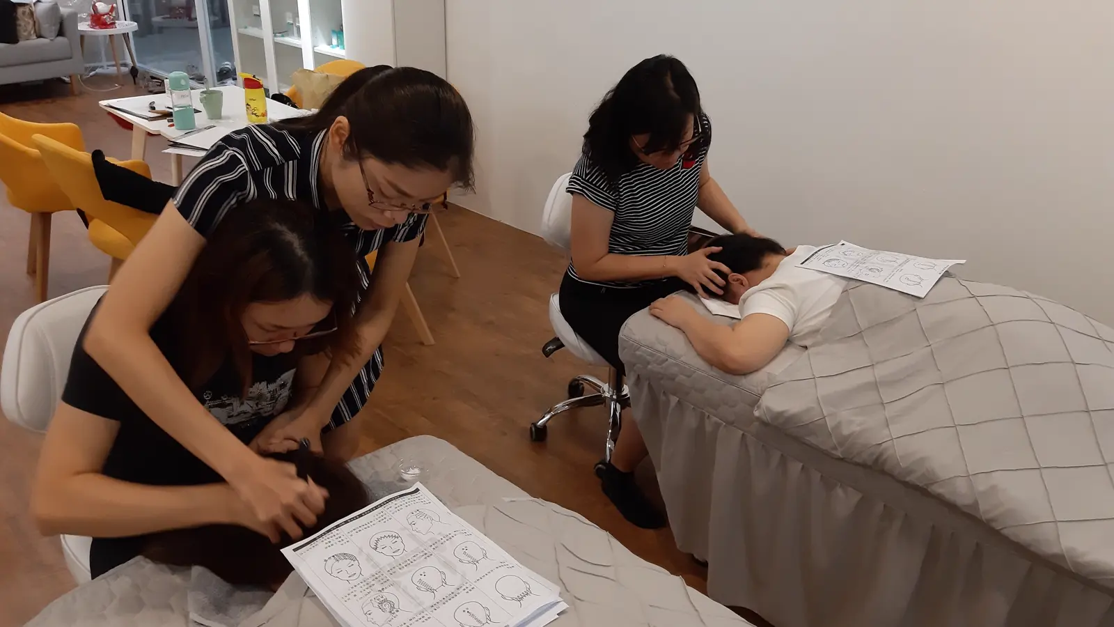 A group bojin lesson with hands-on head and scalp technique