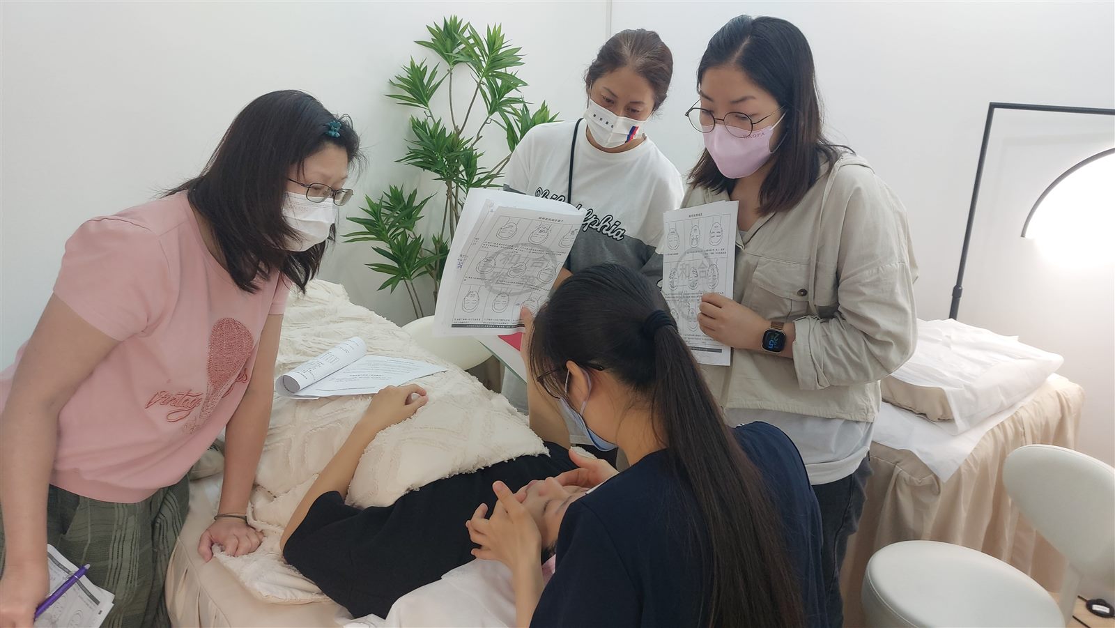 A woman in her fifties resting a smooth bojin stick along her brow bone in soft daylight