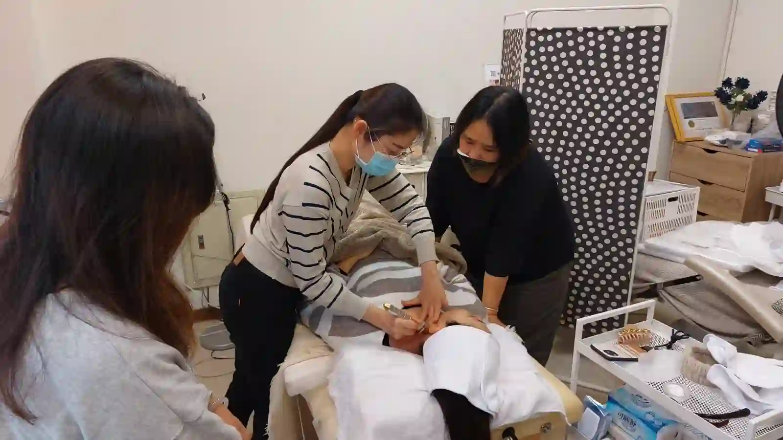 Two hands working closely on the lower face and jaw, the area most affected by clenching